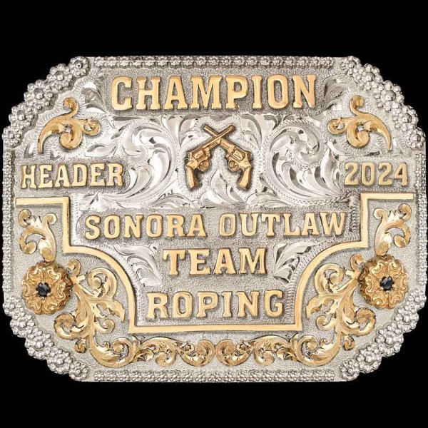 The Walla Walla Belt Buckle is fancy yet classy with its intricate design. Hand-engraved on a German Silver base, it features Scroll elements laid in Jeweler’s Bronze, flowers with central stones, 